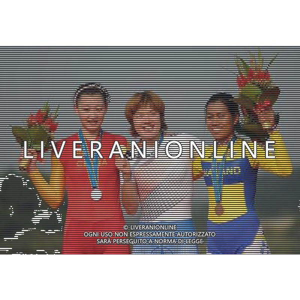 (101120) -- GUANGZHOU, Nov. 20, 2010 () -- Lee Min Hye (C) of South Korea, Jiang Fan (L) of China and Chanpeng Nontasin of Thailand pose during the awarding ceremony of the women\'s individual time trial of cycling road at the 16th Asian Games in Guangzhou, south China\'s Guangdong Province, Nov. 20, 2010. Lee Min Hye won the gold with 49 minutes 38.35 seconds. Jiang Fan and Chanpeng Nontasin respectively won the silver and the bronze with 50 minutes 4.62 seconds and 51 minutes 37.11 seconds. (/Li Ga) ©photoshot/Agenzia Aldo Liverani Sas - ITALY ONLY - CINA: 16mi Giochi Asiatici