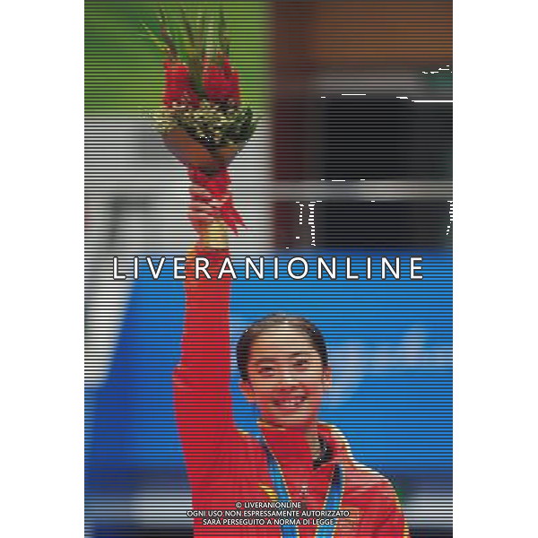 (101120) -- GUANGZHOU, Nov. 20, 2010 () -- Gold medalist Wang Shixian reacts during the awarding ceremony for the women\'s singles of badminton at the 16th Asian Games in Guangzhou, south China\'s Guangdong Province, Nov. 20, 2010. (/Lu Hanxin) ©photoshot/Agenzia Aldo Liverani Sas - ITALY ONLY - CINA: 16mi Giochi Asiatici