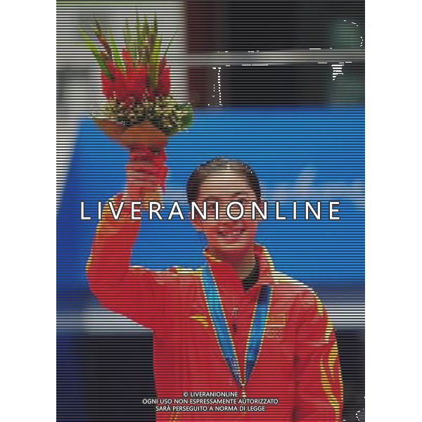 (101120) -- GUANGZHOU, Nov. 20, 2010 () -- Gold medalist Wang Shixian reacts during the awarding ceremony for the women\'s singles of badminton at the 16th Asian Games in Guangzhou, south China\'s Guangdong Province, Nov. 20, 2010. (/Lu Hanxin) ©photoshot/Agenzia Aldo Liverani Sas - ITALY ONLY - CINA: 16mi Giochi Asiatici