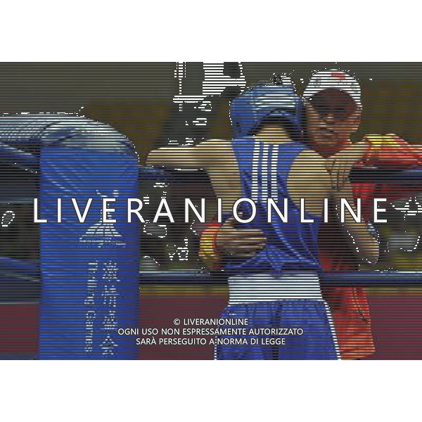 (101120) -- FOSHAN, Nov. 20, 2010 () -- Zou Shiming (front) of China hugs with the coach before the men\'s 46-49 kg match of boxing competition against Jasurbek Latipov of Uzbekistan at the 16th Asian Games in Guangzhou, south China\'s Guangdong Province, Nov. 20, 2010. Zou Shiming won 9-2. (/Gong Lei) ©photoshot/Agenzia Aldo Liverani Sas - ITALY ONLY - CINA: 16mi Giochi Asiatici