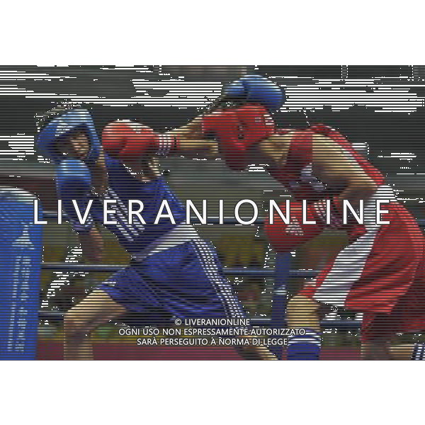(101120) -- FOSHAN, Nov. 20, 2010 () -- Zou Shiming (L) of China competes during the men\'s 46-49 kg match of boxing competition against Jasurbek Latipov of Uzbekistan at the 16th Asian Games in Guangzhou, south China\'s Guangdong Province, Nov. 20, 2010. Zou Shiming won 9-2. (/Gong Lei) ©photoshot/Agenzia Aldo Liverani Sas - ITALY ONLY - CINA: 16mi Giochi Asiatici