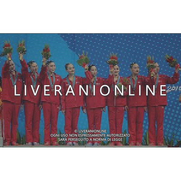 (101120) -- FOSHAN, Nov. 20, 2010 () -- Team DPRK pose on the podium during the awarding ceremony for the women\'s synchronised swimming team free routine at the 16th Asian Games in Foshan, south China\'s Guangdong Province, Nov. 20, 2010. DPRK took the bronze with 173.000 points. (/Fei Maohua) ©photoshot/Agenzia Aldo Liverani Sas - ITALY ONLY - CINA: 16mi Giochi Asiatici
