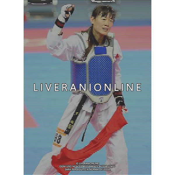 (101120) -- GUANGZHOU, Nov. 20, 2010 () -- Luo Wei of China celebrates her victory after the final of women\'s under 73kg of taekwondo against Feruza Yergeshova of Kazakhstan at the 16th Asian Games in Guangzhou, south China\'s Guangdong Province, Nov. 20, 2010. Luo Wei claimed the title with 5-4. (/Chen Kai)(wll) ©photoshot/Agenzia Aldo Liverani Sas - ITALY ONLY - CINA: 16mi Giochi Asiatici