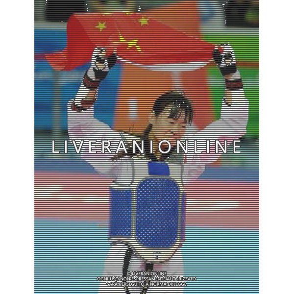 (101120) -- GUANGZHOU, Nov. 20, 2010 () -- Luo Wei of China celebrates her victory after the final of women\'s under 73kg of taekwondo against Feruza Yergeshova of Kazakhstan at the 16th Asian Games in Guangzhou, south China\'s Guangdong Province, Nov. 20, 2010. Luo Wei claimed the title with 5-4. (/Chen Kai)(wll) ©photoshot/Agenzia Aldo Liverani Sas - ITALY ONLY - CINA: 16mi Giochi Asiatici