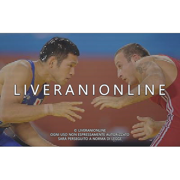 (101121) -- GUANGZHOU, Nov. 21, 2010 () -- Tsutomu Fujimura(L) of Japan fights against Besiki Saldadze of Uzbekistan during the bronze medal match of Men\'s Greco-Roman 66kg Final of Wrestling at the 16th Asian Games in Guangzhou, south China\'s Guangdong Province, Nov. 21, 2010. Tsutomu Fujimura won the match and took the bronze. (/Yan Yan)(wll) ©photoshot/Agenzia Aldo Liverani Sas - ITALY ONLY - CINA: 16mi Giochi Asiatici