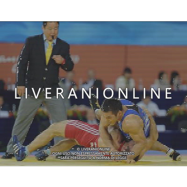 (101121) -- GUANGZHOU, Nov. 21, 2010 () -- Tsutomu Fujimura(Top) of Japan fights against Besiki Saldadze of Uzbekistan during the bronze medal match of Men\'s Greco-Roman 66kg Final of Wrestling at the 16th Asian Games in Guangzhou, south China\'s Guangdong Province, Nov. 21, 2010. Tsutomu Fujimura won the match and took the bronze. (/Yan Yan)(wll) ©photoshot/Agenzia Aldo Liverani Sas - ITALY ONLY - CINA: 16mi Giochi Asiatici
