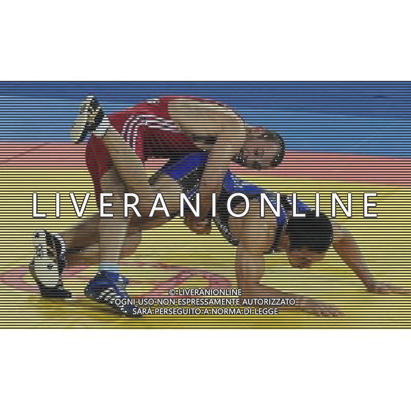 (101121) -- GUANGZHOU, Nov. 21, 2010 () -- Tsutomu Fujimura(R) of Japan fights against Besiki Saldadze of Uzbekistan during the bronze medal match of Men\'s Greco-Roman 66kg Final of Wrestling at the 16th Asian Games in Guangzhou, south China\'s Guangdong Province, Nov. 21, 2010. Tsutomu Fujimura won the match and took the bronze. (/Li Yong)(wll) ©photoshot/Agenzia Aldo Liverani Sas - ITALY ONLY - CINA: 16mi Giochi Asiatici