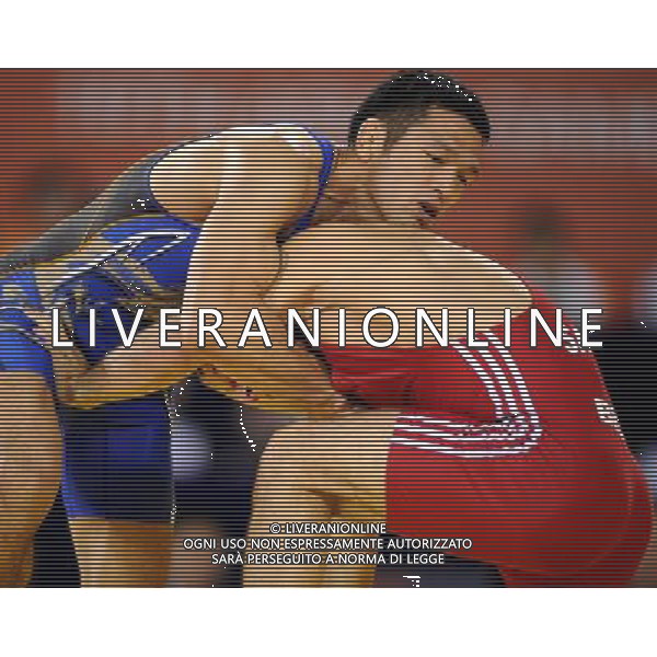 (101121) -- GUANGZHOU, Nov. 21, 2010 () -- Tsutomu Fujimura(L) of Japan fights against Besiki Saldadze of Uzbekistan during the bronze medal match of Men¡¯s Greco-Roman 66kg Final of Wrestling at the 16th Asian Games in Guangzhou, south China\'s Guangdong Province, Nov. 21, 2010. Tsutomu Fujimura won the match and took the bronze. (/Yan Yan)(wll) ©photoshot/Agenzia Aldo Liverani Sas - ITALY ONLY - CINA: 16mi Giochi Asiatici