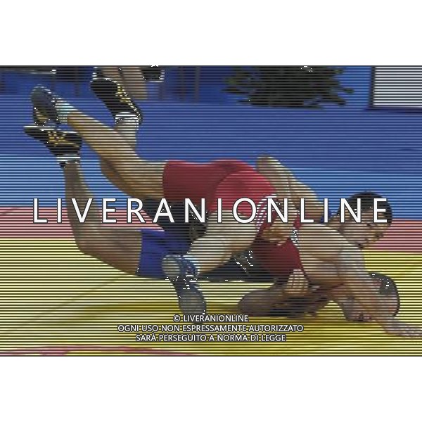 (101121) -- GUANGZHOU, Nov. 21, 2010 () -- Tsutomu Fujimura(Back) of Japan fights against Besiki Saldadze of Uzbekistan during the bronze medal match of Men\'s Greco-Roman 66kg Final of Wrestling at the 16th Asian Games in Guangzhou, south China\'s Guangdong Province, Nov. 21, 2010. Tsutomu Fujimura won the match and took the bronze. (/Li Yong)(wll) ©photoshot/Agenzia Aldo Liverani Sas - ITALY ONLY - CINA: 16mi Giochi Asiatici