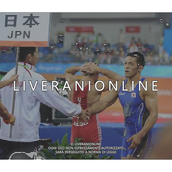 (101121) -- GUANGZHOU, Nov. 21, 2010 () -- Tsutomu Fujimura(R) of Japan is congratulated by his team member after the bronze medal match of Men¡¯s Greco-Roman 66kg Final of Wrestling against Besiki Saldadze of Uzbekistan at the 16th Asian Games in Guangzhou, south China\'s Guangdong Province, Nov. 21, 2010. Tsutomu Fujimura won the match and took the bronze. (/Yan Yan)(wll) ©photoshot/Agenzia Aldo Liverani Sas - ITALY ONLY - CINA: 16mi Giochi Asiatici