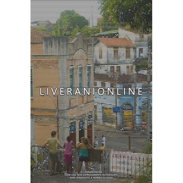 Children look out over a balcony onto the bohemian neighbourhood of Santa Teresa in Rio de Janeiro, Brazil © Ed Stocker - Photoshot - Ag. Aldo Liverani sas ITALY ONLY VIAGGIO - VIAGGIARE - REPORTAGE BRASILE