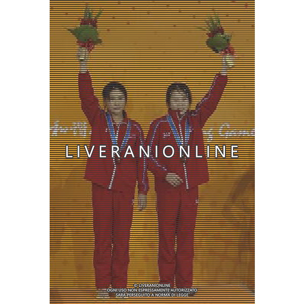 (101123) -- GUANGZHOU, Nov. 23, 2010 () -- Bronze medalists Choe Kum Hui (R) and Kim Un Hyang of DPRK celebrate on the podium during the awarding ceremony for the women\'s 10m platform of diving event at the 16th Asian Games in Guangzhou, south China\'s Guangdong Province, Nov. 23, 2010. (/Fei Maohua) ©PHOTOSHOT/Agenzia Aldo Liverani Sas - ITALY ONLY: CINA - 16mi GIOCHI OLIMPICI ASIATICI
