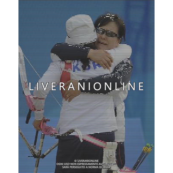 (101123) -- GUANGZHOU, Nov. 23, 2010 () -- South Korea\'s archer Yun Ok Hee(Front) hugs with the coach after the women\'s individual event final of archery at the 16th Asian Games in Guangzhou, south China\'s Guangdong Province, Nov. 23, 2010. Yun Ok Hee beat China\'s Cheng Ming by 6-0 and won the title. (/Gesang Dawa)(sss) ©PHOTOSHOT/Agenzia Aldo Liverani Sas - ITALY ONLY: CINA - 16mi GIOCHI OLIMPICI ASIATICI