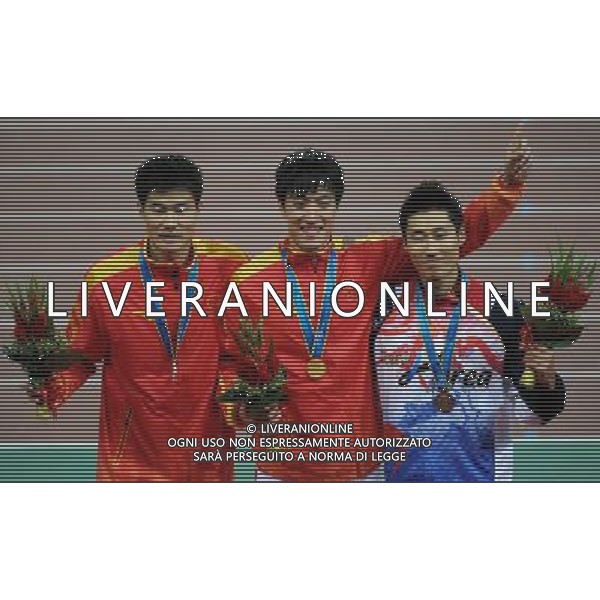 Champion Liu Xiang (C) and runner-up Shi Dongpeng (L) of China celebrate with bronze winner Park Tae-kyong of South Korea during the award ceremony of the men\'s 110m hurdles final at the 16th Asian Games in Guangzhou in south China\'s Guangdong province on Wednesday, Nov. 24, 2010. Liu Xiang won gold in 13.09 seconds.(Photo By Kun Ge/ColorChinaPhoto) - AG. ALDO LIVERANI SAS ITALY ONLY CINA - 16mi GIOCHI OLIMPICI ASIATICI 2010