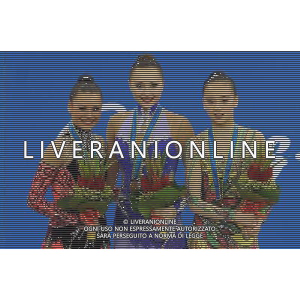 (101126) -- GUANGZHOU, Nov. 26, 2010 () -- Gold medalist Anna Alyabyeva (C) of Kazakhstan, silver medalist Ulyana Trofimova(L) and bronze medalist Son Yeon Jae of South Korea pose on the podium during the awarding ceremony for the individual all-around event of Rhythmic Gymnastics at the 16th Asian Games in Guangzhou, south China\'s Guangdong Province, Nov. 26, 2010. (/Wang Lei) - Xinhua/Photoshot - Ag. Aldo Liverani sas ITALY ONLY CINA - 16mi GIOCHI ASIATICI 2010: GINNASTICA RITMICA