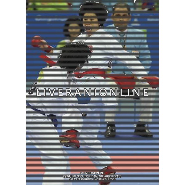 (101126) -- GUANGZHOU, Nov. 26, 2010 () -- Chan Ka Man (R) of Hong Kong, China competes against Chang Ting of Chinese Taipei during the women\'s -61kg bronze medal match of Karate at the 16th Asian Games in Guangzhou, south China\'s Guangdong Province, Nov. 26, 2010. Chan Ka Man won 3-0 and got the bronze medal of the category. (/Gesang Dawa) - Xinhua/Photoshot - Ag. Aldo Liverani sas ITALY ONLY CINA - 16mi GIOCHI OLIMPICI ASIATICI: KARATE