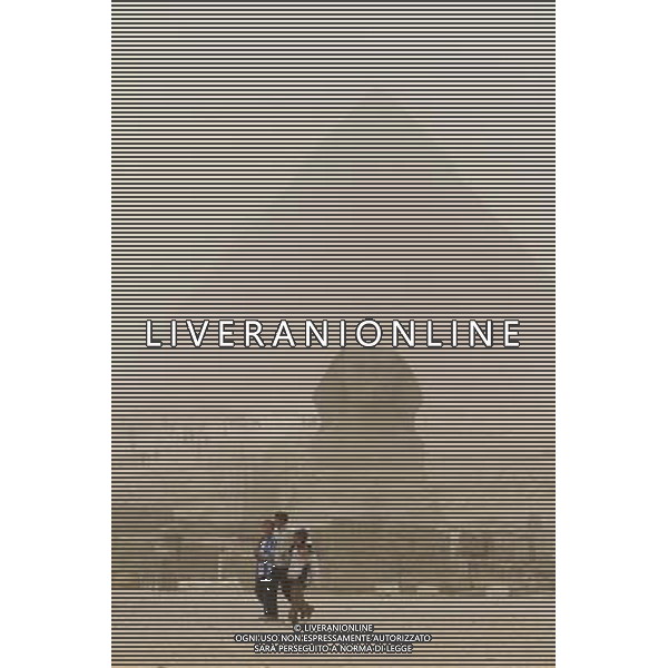 (101212) -- CAIRO, Dec. 12, 2010 () -- Boys walk in front of the Sphinx during the dust storm in Cairo, capital of Egypt, Dec. 12, 2010. (/Nasser Nouri) (zw) AG. ALDO LIVERANI SAS ITALY ONLY