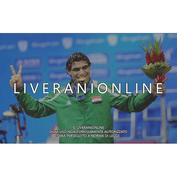 (101214) -- GUANGZHOU, Dec. 14, 2010 () -- Rasool Mohsin of Iraq waves to the audience during the awarding ceremony after the men\'s -56kg of Powerlifting at the Guangzhou 2010 Asian Para Games in Guangzhou, south China\'s Guangdong Province, Dec. 14, 2010. Rasool Mohsin of Irag won the gold medal of the event. (/Fan Changguo) (xm) AG. ALDO LIVERANI SAS ITALY ONLY