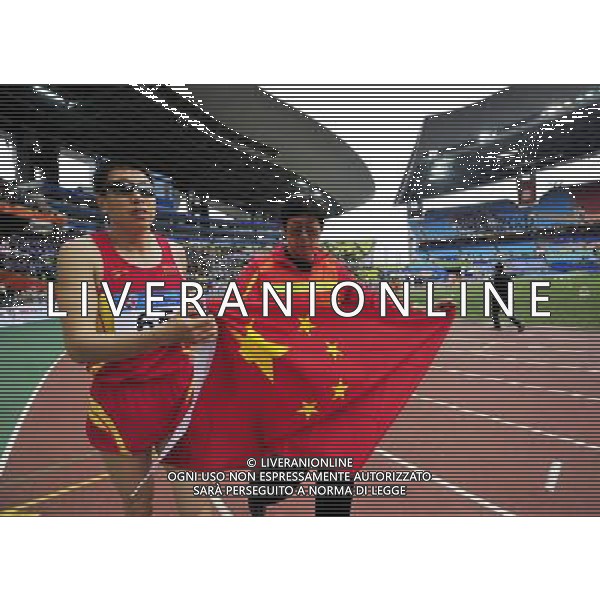 (101214) -- GUANGZHOU, Dec. 14, 2010 () -- China\'s Li Duan (L) celebrates with his escort after winning the men\'s long jump F11 final match at the Guangzhou 2010 Asian Para Games in Guangzhou, south China\'s Guangdong Province, Dec. 14, 2010. Li won the gold medal of the event with 5.96 meters. (/Chen Yehua) (xm) AG. ALDO LIVERANI SAS ITALY ONLY