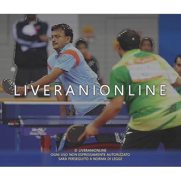 (101214) -- GUANGZHOU, Dec. 14, 2010 () -- Pawan Kumar Sharma (L) of India returns to Husam Aljeraifani of Saudi Arabia during the group C match 9 of the men\'s singles TT 6-7 of the table tennis competition at the Guangzhou 2010 Asian Para Games in Guangzhou, south China\'s Guangdong Province, Dec. 14, 2010. Pawan Kumar Sharma won 3-0. (/Xu Yu) AG. ALDO LIVERANI SAS ITALY ONLY