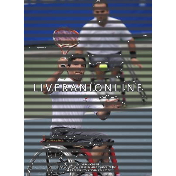 (101214) -- GUANGZHOU, Dec. 14, 2010 () -- Hossein Mamipour and Mohammad Yaghoubi (front) of Iran compete during the 1st round match of men\'s doubles of wheelchair tennis competition against China\'s Feng Xiaomin and Wei Zujun at the Guangzhou 2010 Asian Para Games in Guangzhou, south China\'s Guangdong Province, Dec. 14, 2010. Feng Xiaomin and Wei Zujun won 2-1. (/Yue Yuewei) AG. ALDO LIVERANI SAS ITALY ONLY