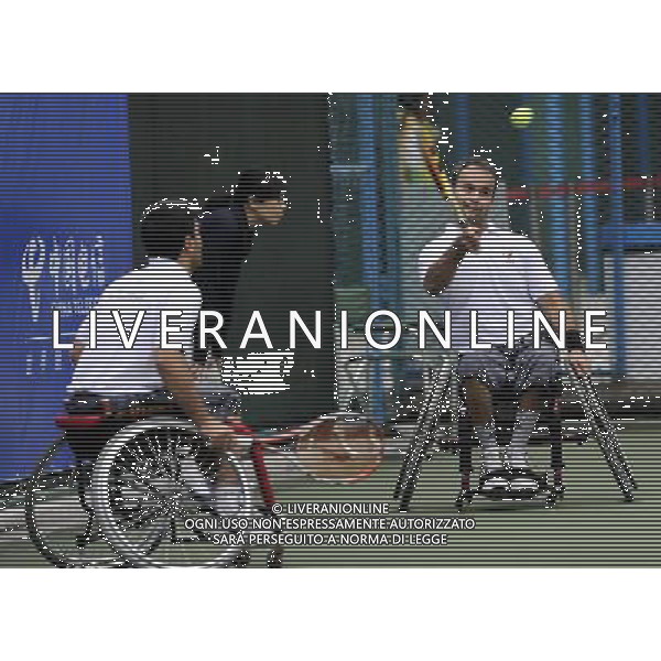 (101214) -- GUANGZHOU, Dec. 14, 2010 () -- Hossein Mamipour (R) and Mohammad Yaghoubi of Iran compete during the 1st round match of men\'s doubles of wheelchair tennis competition against China\'s Feng Xiaomin and Wei Zujun at the Guangzhou 2010 Asian Para Games in Guangzhou, south China\'s Guangdong Province, Dec. 14, 2010. Feng Xiaomin and Wei Zujun won 2-1. (/Yue Yuewei) AG. ALDO LIVERANI SAS ITALY ONLY