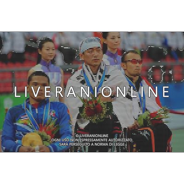 (101214) -- GUANGZHOU, Dec. 14, 2010 () -- Gold medalist South Korea\'s Hong Sukman (C), silver medalist Japan\'s Jun Hiromichi (R) and bronze medalist Thailand\'s Sopa Intasen reacts during the awarding ceremony of men\'s 800m T53 of athletics competition at the Guangzhou 2010 Asian Para Games in Guangzhou, south China\'s Guangdong Province, Dec. 14, 2010. (/Ren Junchuan) AG. ALDO LIVERANI SAS ITALY ONLY
