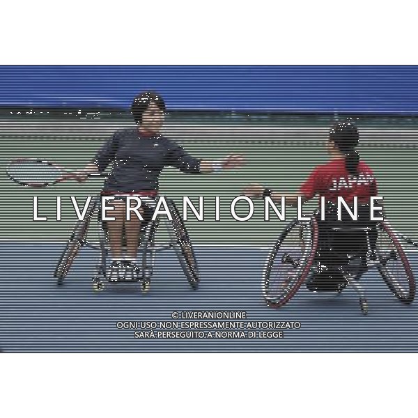 (101214) -- GUANGZHOU, Dec. 14, 2010 () -- Japan\'s Yuko Okabe (R) and Kanako Komori react during round robin of the women\'s doubles of wheelchair tennis competition against Huang Huimin and Huang Jinlian of China at the Guangzhou 2010 Asian Para Games in Guangzhou, south China\'s Guangdong Province, Dec. 14, 2010. Yuko Okabe and Kanako Komori won 2-0. (/Yue Yuewei) AG. ALDO LIVERANI SAS ITALY ONLY