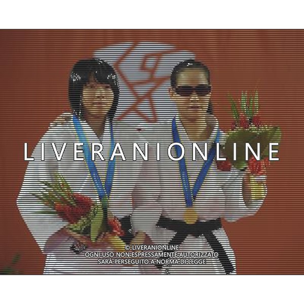 (101214) -- GUANGZHOU, Dec. 14, 2010 () -- Gold medalist China\'s Guo Huaping (R) and silver medalist Lee Kai Lin of Chinese Taipei react during the awarding ceremony of the women\'s 48kg judo competition at the Guangzhou 2010 Asian Para Games in Guangzhou, south China\'s Guangdong Province, Dec. 14, 2010. (/Han Chuanhao) AG. ALDO LIVERANI SAS ITALY ONLY