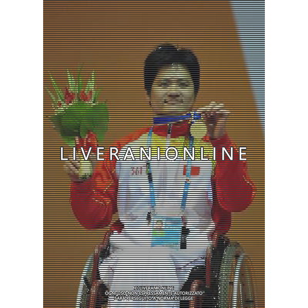 (101214) -- GUANGZHOU, Dec. 14, 2010 () -- China\'s Hu Daoliang reacts during the awarding ceremony of the men\'s individual foil category B final of wheelchair fencing competition at the Guangzhou 2010 Asian Para Games in Guangzhou, south China\'s Guangdong Province, Dec. 14, 2010. Hu Daoliang won the gold of the event. (/Liang Xu) AG. ALDO LIVERANI SAS ITALY ONLY