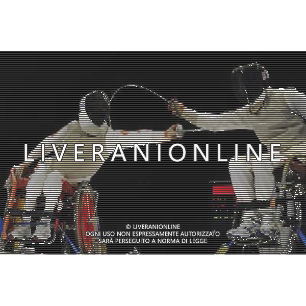 (101214) -- GUANGZHOU, Dec. 14, 2010 () -- China\'s Hu Daoliang (L) competes during the men\'s individual foil category B final of wheelchair fencing competition against Chung TC of China\'s Hong Kong at the Guangzhou 2010 Asian Para Games in Guangzhou, south China\'s Guangdong Province, Dec. 14, 2010. Hu Daoliang won the gold of the event. (/Liang Xu) AG. ALDO LIVERANI SAS ITALY ONLY