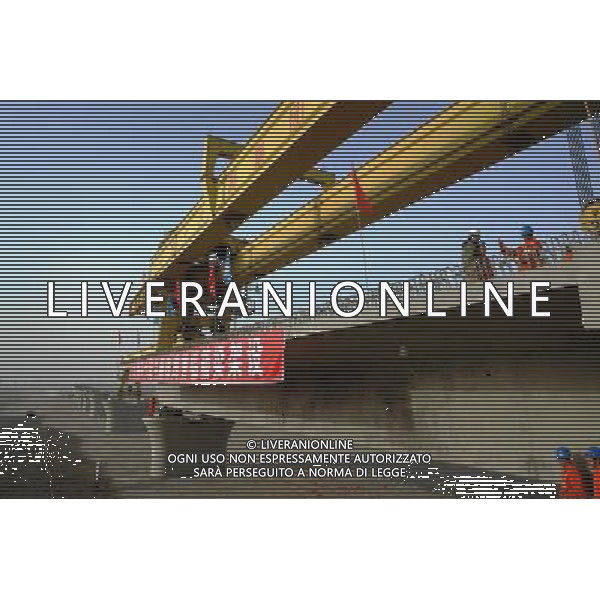 (101201) -- TURPAN, Dec. 1, 2010 () -- Wokers lay the first box girder onto bridge pillars of the Lanzhou-Xinjiang Railway crossing the wind field, which is dubbed as \'ghost\' for that windstorms of above 100 km per hour often running through it which once overthrown a train in 2007, in Turpan, northwest China\'s Xinjiang Uygur Autonomous Region, Nov. 30, 2010. Workers began laying 900-ton box girders on Tuesday onto those pillars with a total length of 7.795 km in the \'ghost\' wind field. The box girder laying operation will be finished by next April. (/Jiang Xiaoming) (zn) AG. ALDO LIVERANI SAS ITALY ONLY