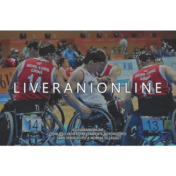 (101215) -- GUANGZHOU, Dec. 15, 2010 () -- Choi Ho Sung (C) of South Korea is helped by Chung Cheuk Ting (L) and Cheng Hoi Kot Jackit (R) of Hong Kong of China during the men\'s wheelchair basketball preliminaries Group B match against at the Guangzhou 2010 Asian Para Games in Guangzhou, south China\'s Guangdong Province, Dec. 15, 2010. (/Hao Tongqian) AG. ALDO LIVERANI SAS ITALY ONLY