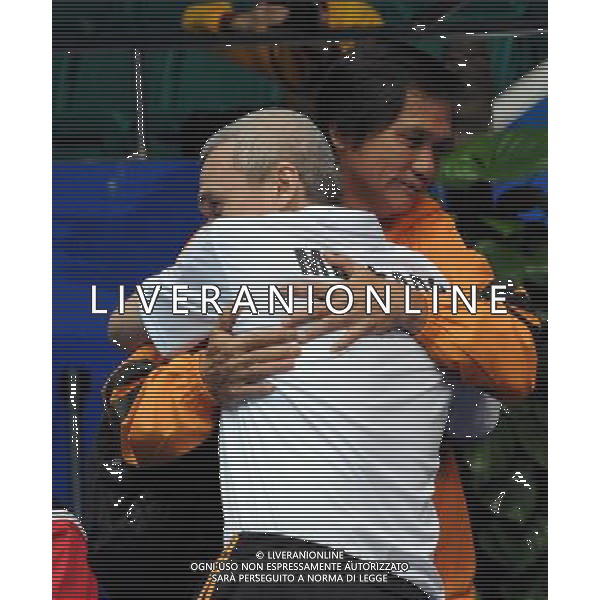 (101215) -- GUANGZHOU, Dec. 15, 2010 () -- Md Radhi Juhari (front) of Malaysia hugs with his coach after winning bronze in the men\'s singles BMSTL1 bronze medal match of badminton event against Subpong Meepian of Thailand at the Guangzhou 2010 Asian Para Games in Guangzhou, south China\'s Guangdong Province, Dec. 15, 2010. (/Wang Song) AG. ALDO LIVERANI SAS ITALY ONLY