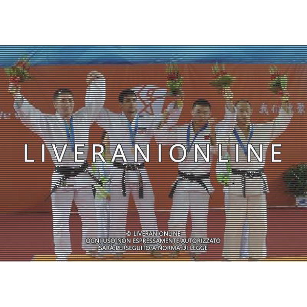 (101215) -- GUANGZHOU, Dec. 15, 2010 () -- Gold medalist Iran\'s Saeid Rahmati (2nd L), silver medalist Mongolia\'s Munkhbat Aajim (1st L), bronze medalist Japan\'s Makoto Hirose and China\'s Zhao Xu (2nd R) react during the awarding ceremony of the men\'s 66kg judo competition at the Guangzhou 2010 Asian Para Games in Guangzhou, south China\'s Guangdong Province, Dec. 15, 2010. (/Han Chuanhao) AG. ALDO LIVERANI SAS ITALY ONLY