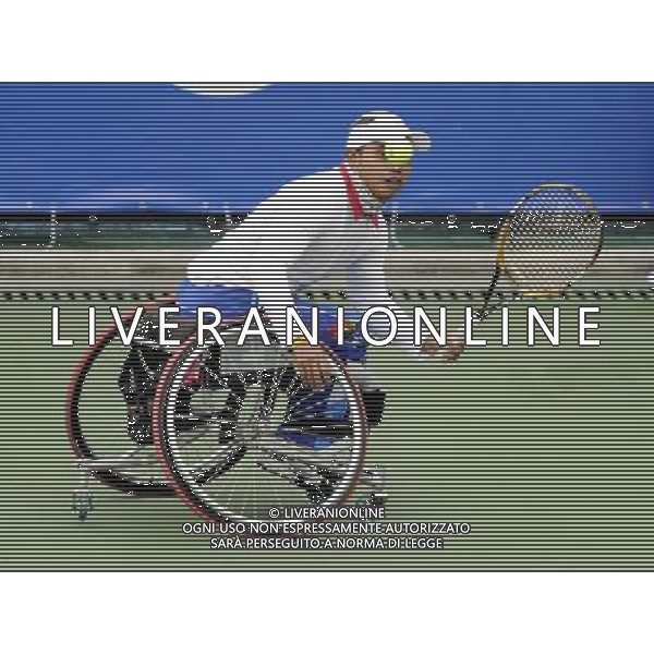 (101216) -- GUANGZHOU, Dec. 16, 2010 () -- Thailand\'s Suthi Khlongrua hits a shot to Japan\'s Fujimoto Yoshinobu during the quarterfinal of the men\'s wheelchair tennis singles at the 2010 Asian Para Games in Guangzhou, capital city of south China\'s Guangdong Province, Dec. 16, 2010. Suthi Khlongrua lost the match 0-2. (/Yue Yuewei) (zc) AG. ALDO LIVERANI SAS ITALY ONLY