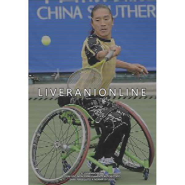 (101216) -- GUANGZHOU, Dec. 16, 2010 () -- South Korea\'s Kim Sam Ju hits a shot to Japan\'s Kunieda Shingo during the quarterfinal of the men\'s wheelchair tennis singles at the 2010 Asian Para Games in Guangzhou, capital city of south China\'s Guangdong Province, Dec. 16, 2010. Kim Sam Ju lost the match 0-2. (/Yue Yuewei) (zc) AG. ALDO LIVERANI SAS ITALY ONLY