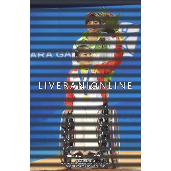 (101216) -- GUANGZHOU, Dec. 16, 2010 () -- China\'s Li Qian celebrates on the awarding podium after winning the women\'s table tennis singles TT1-3 final at the 2010 Asian Para Games in Guangzhou, capital city of south China\'s Guangdong Province, Dec. 16, 2010. Li beat her compatriot Liu Jing in the final by 3-0 and took the gold medal of the event. (/Xu Yu) (zc) AG. ALDO LIVERANI SAS ITALY ONLY