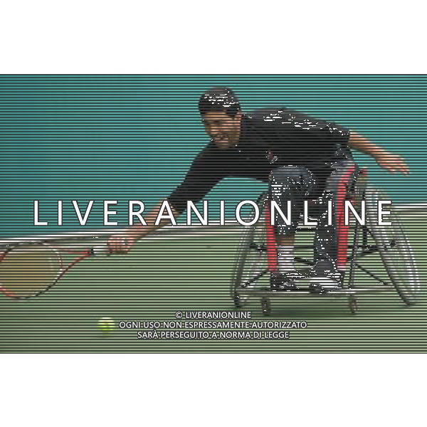 (101216) -- GUANGZHOU, Dec. 16, 2010 () -- Iran\'s Mohammad Yaghoubi hits a shot to Malaysia\'s Kee Kim Hong during the men\'s wheelchair tennis singles consolation semifinal at the 2010 Asian Para Games in Guangzhou, capital city of south China\'s Guangdong Province, Dec. 16, 2010. Yaghoubi advanced into the final after a 2-0 win. (/Yue Yuwei) (zc) AG. ALDO LIVERANI SAS ITALY ONLY