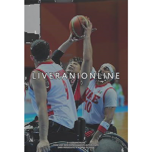 (101216) -- GUANGZHOU, Dec. 16, 2010 () -- Miyajima Tetsuya (C) of Japan vies with two players of United Arab Emirates during the men\'s wheelchair basketball preliminary match between Japan and United Arab Emirates at the 2010 Asian Para Games in Guangzhou, capital city of south China\'s Guangdong Province, Dec. 16, 2010. Japan beat United Arab Emirates by 90-25. (/Hao Tongqian) (zc) AG. ALDO LIVERANI SAS ITALY ONLY