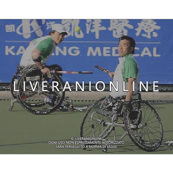 (101216) -- GUANGZHOU, Dec. 16, 2010 () -- South Korean pair Lee Ha Gel (R) and Oh Sang Ho compete with Iraqi pair Mohammed Hamdan and Mohammed Thalij during the quarterfinal of the men\'s wheelchair tennis doubles at the 2010 Asian Para Games in Guangzhou, capital city of south China\'s Guangdong Province, Dec. 16, 2010. The South Korean pair won 2-0 and advanced into the semifinal. (/Yue Yuewei) (zc) AG. ALDO LIVERANI SAS ITALY ONLY