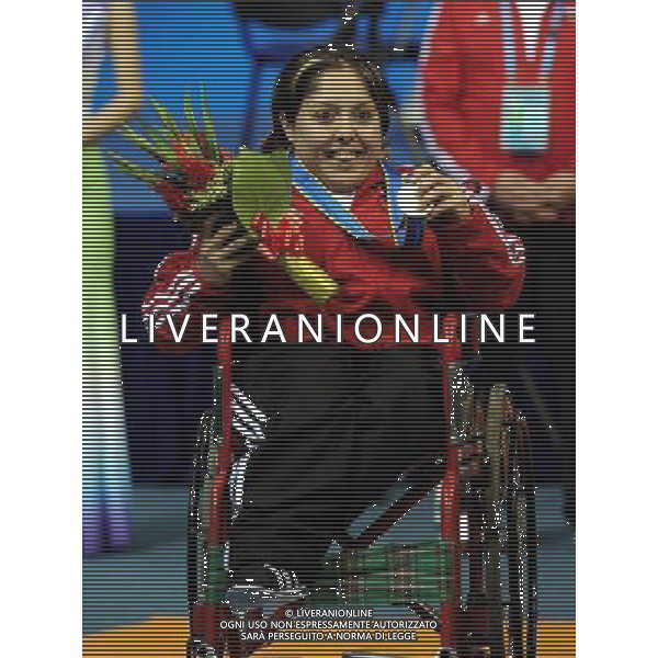 (101213) -- GUANGZHOU, Dec. 13, 2010 () -- Silver medalist Noura Baddour of Syria smiles during the awarding ceremony for the women\'s powerlifting -40kg event at the Guangzhou 2010 Asian Para Games in Guangzhou, south China\'s Guangdong Province, Dec. 13, 2010. (/Fan Changguo) AG. ALDO LIVERANI SAS ITALY ONLY