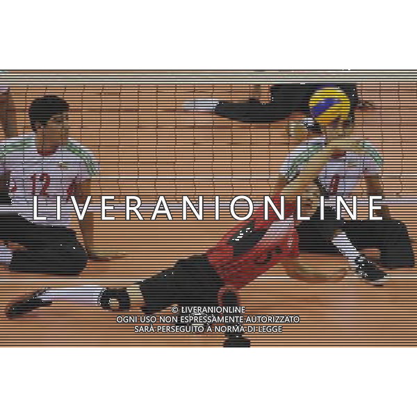 (101213) -- GUANGZHOU, Dec. 13, 2010 () -- Kaname Nakayama (front) of Japan competes during the preliminary pool B match of men\'s volleyball sitting against Iran at the Guangzhou 2010 Asian Para Games in Guangzhou, south China\'s Guangdong Province, on Dec. 13, 2010. Japan lost 0-3. (/Jiang Hongjing) AG. ALDO LIVERANI SAS ITALY ONLY