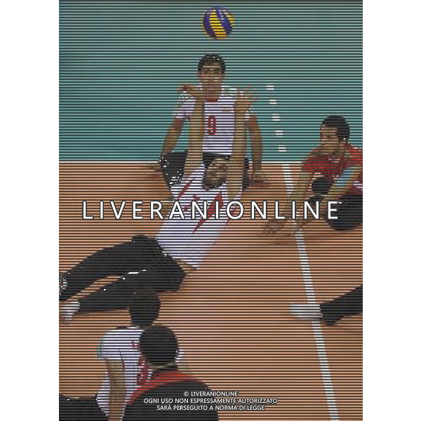 (101213) -- GUANGZHOU, Dec. 13, 2010 () -- Majid Lashgarisanami (C) of Iran competes during the preliminary pool B match of men\'s volleyball sitting against Japan at the Guangzhou 2010 Asian Para Games in Guangzhou, south China\'s Guangdong Province, on Dec. 13, 2010. Iran won 3-0. (/Jiang Hongjing) AG. ALDO LIVERANI SAS ITALY ONLY