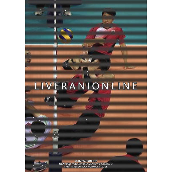 (101213) -- GUANGZHOU, Dec. 13, 2010 () -- Kaname Nakayama (C) and Koji Tanaka (below) of Japan compete during the preliminary pool B match of men\'s volleyball sitting against Iran at the Guangzhou 2010 Asian Para Games in Guangzhou, south China\'s Guangdong Province, on Dec. 13, 2010. Japan lost 0-3. (/Jiang Hongjing) AG. ALDO LIVERANI SAS ITALY ONLY