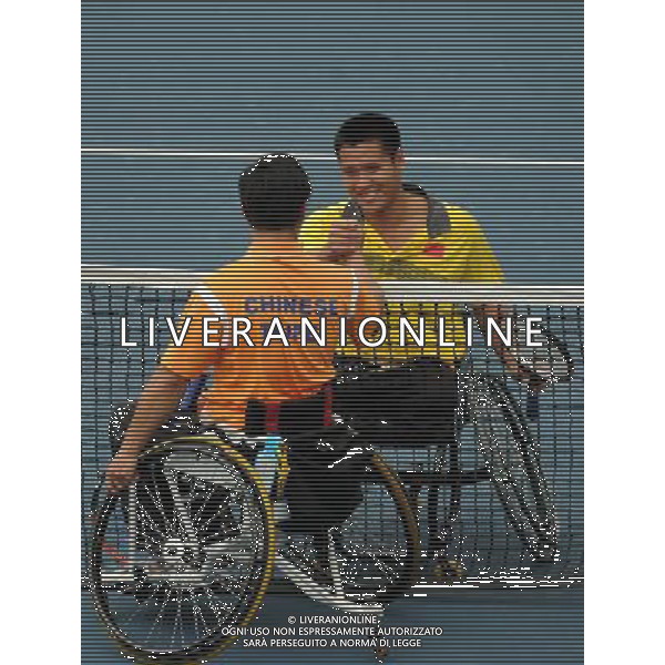 (101213) -- GUANGZHOU, Dec. 13, 2010 () -- Feng Xiaomin (R) of China shakes hands with Tai Chia Yang of Chinese Taipei after the 1st round of men\'s singles open of wheelchair tennis at the Guangzhou 2010 Asian Para Games in Guangzhou, south China\'s Guangdong Province, on Dec. 13, 2010. Feng won 2-0. (/Yue Yuewei) AG. ALDO LIVERANI SAS ITALY ONLY
