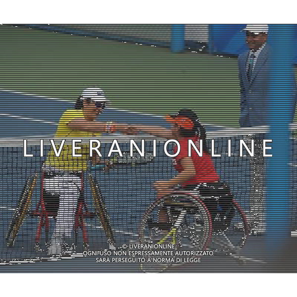 (101213) -- GUANGZHOU, Dec. 13, 2010 () -- Dong Fuli (L) of China shakes hands with Yui Kamiji of Japan during the 1st round of women\'s singles open of wheelchair tennis at the Guangzhou 2010 Asian Para Games in Guangzhou, south China\'s Guangdong Province, on Dec. 13, 2010. Dong won 2-0. (/Yue Yuewei) AG. ALDO LIVERANI SAS ITALY ONLY