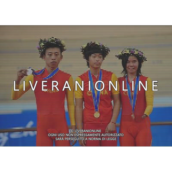 (101213) -- GUANGZHOU, Dec. 13, 2010 () -- China\'s Zhou Jufang (C), Liu Xinyang (L) and Ruan Jianping react during the awarding ceremony of the mixed C1-5, M1KM\'W500M time trial final of cycling track competition at the Guangzhou 2010 Asian Para Games in Guangzhou, south China\'s Guangdong Province, on Dec. 13, 2010. Zhou Jufang won the gold with 1 minute and 8.348 seconds. Liu Xinyang and Ruan Jianping won the silver and the bronze with 1 minute 9.495 seconds and 1 minute 10.678 seconds respectively. (/Lu Hanxin) AG. ALDO LIVERANI SAS ITALY ONLY