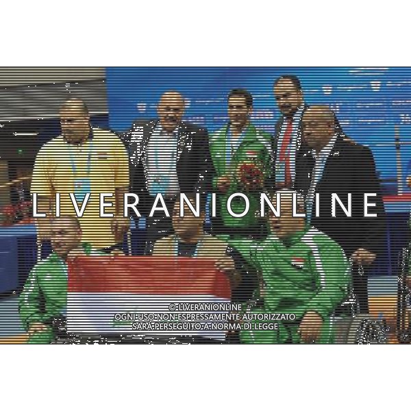 (101213) -- GUANGZHOU, Dec. 13, 2010 () -- Hussein Juboori (C, back) of Iraq poses for photogragh with team members and officials during the awarding ceremony of the men\'s 52kg final of powerlifting competition at the Guangzhou 2010 Asian Para Games in Guangzhou, south China\'s Guangdong Province, on Dec. 13, 2010. Hussein Juboori won the gold medal with 167.5 kg. (/Fan Changguo) AG. ALDO LIVERANI SAS ITALY ONLY
