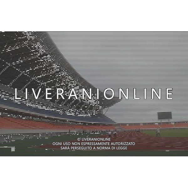 (110118) -- MAPUTO, Jan. 18, 2011 () -- People walk inside Mozambique\'s national stadium in Maputo, capital of Mozambique, Jan. 17, 2011. The newly-completed stadium, which is sponsored by the Chinese government, occupies an area of nearly 270,000 square meters. With a floor space of 42,000 square meters, the stadium has as many as 42,000 seats. (/Liu Dalong) (dyw)